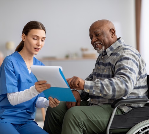 Caregiver reviewing treatment plan with patient.