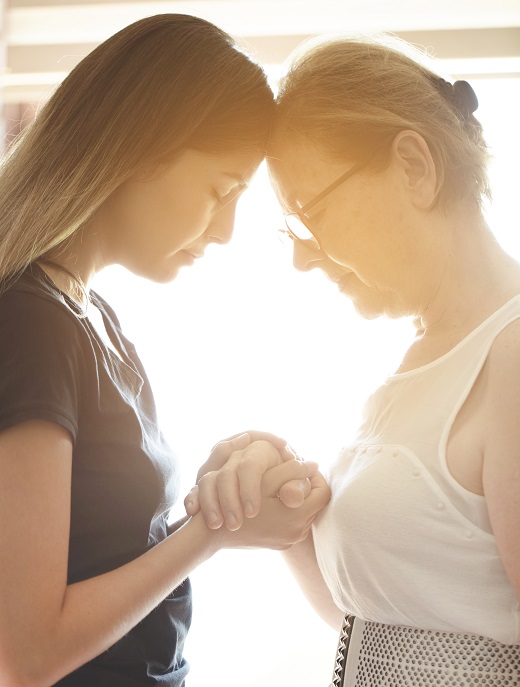 Mother and daughter praying